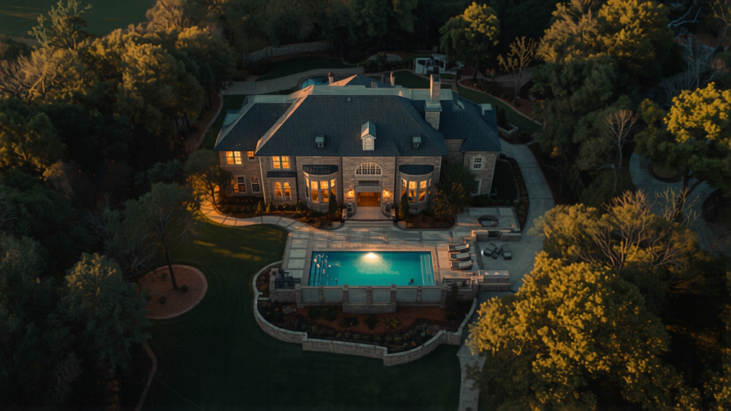 Aerial drone view of a luxury estate home at golden hour
